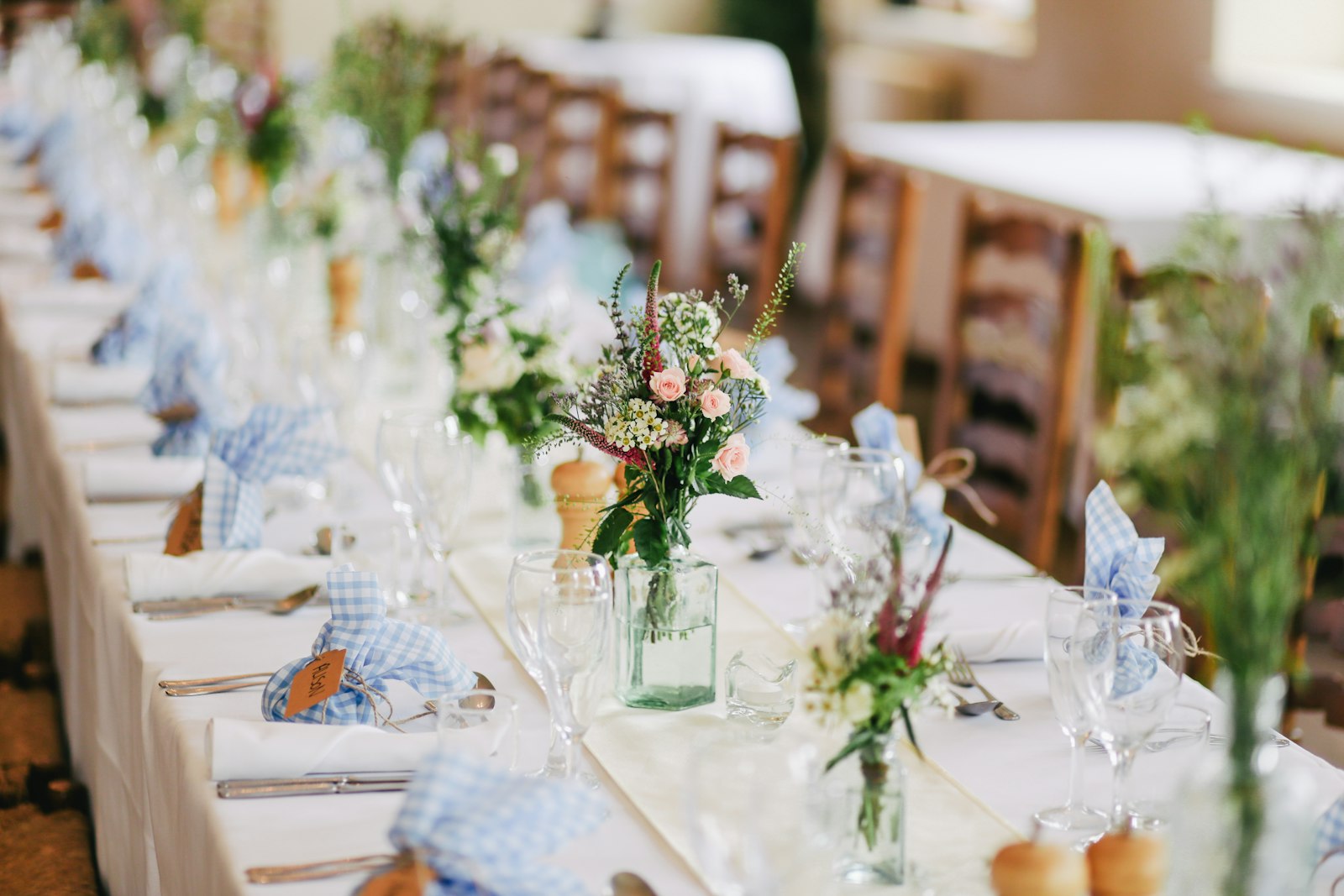 Wedding gift wrapped with twine and dried flowers on a wooden table